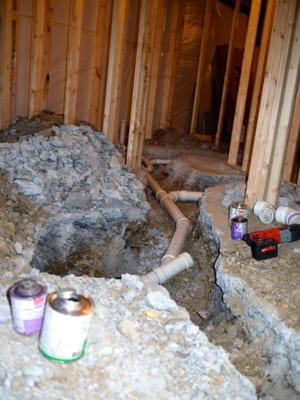 Busting up the concrete to attach the rough-in for the bathroom. The basement did not have one so we had to find the pipe-at ...