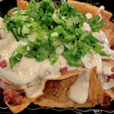 'Supo Nachos - A twist on tradition - Taro chips, corned beef, coconut cream sauce, green onions and cilantro