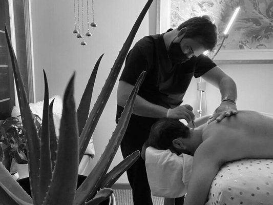 Our Aesthetician Leroy performing a back treatment - Available at Health In Balance