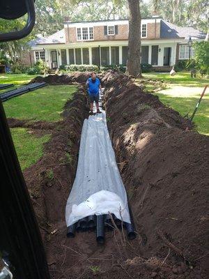 Installing a replacement drain field.