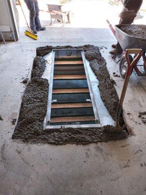 Concrete is poured around, under and on top of the shelter.