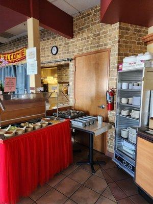 Salad and chutney bar. Plates.