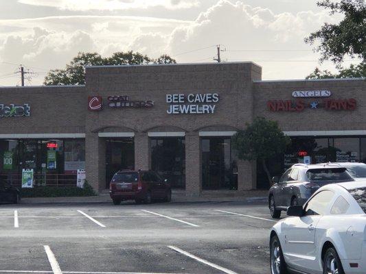 The entrance to the store next to a multitude of other daily life stores.