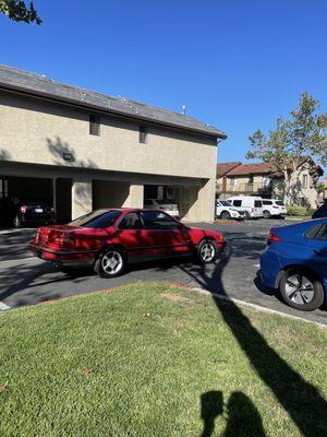 Now a red car is Parked behind my blue car.