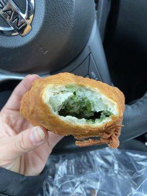 Turnover with spinach, cheese, onion and spices.