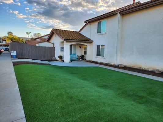 Artificial turf and concrete installed in our front yard to extend the patio and provide a large amount of play space for the kids