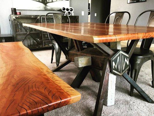 Custom table made out of a combination of concrete and metal woth a wooden top