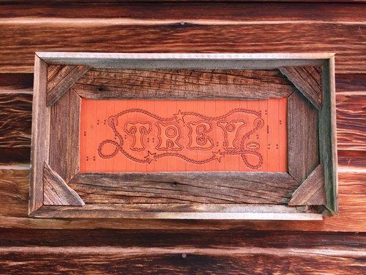 Hand tooled name on veg tanned leather, antiqued and framed in barnwood.