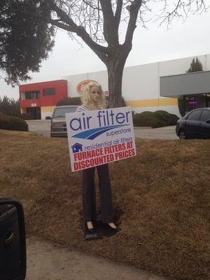 Lol. Funny sign doll in front of the Air Filter Superstore. Great advertising