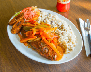 Brown Stew Fish and rice and Peas.