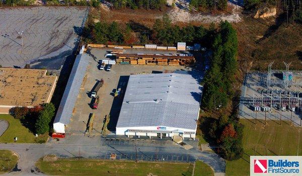 Building materials supplier Builders FirstSource's forklift is moving wood roof trusses.