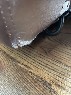 Damaged leather on reclining sofa