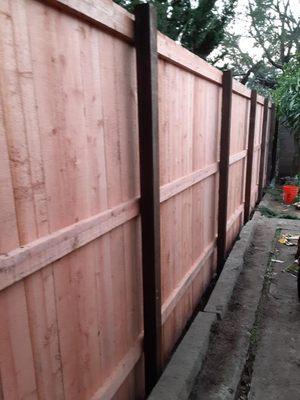 Section of repaired fence with new redwood pickets/fence boards(Kensington, California)