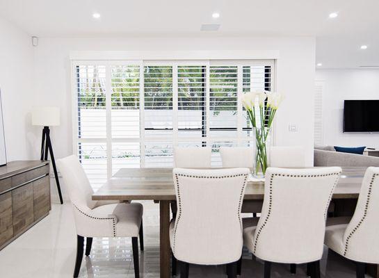 White sliding wood shutters in kitchen.