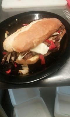 The Phily Steak sandwich.  Steak strips, peppers, onions, mushrooms and gooey melted cheesy. Served with fries