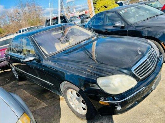 The car sits low in the back and there is rust all the way around and big scratches all over this car. See big white scratch? .