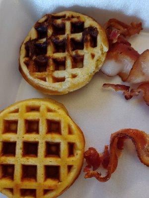 Burnt miniature waffles WITH NO SYRUP and undercooked, cheap bacon!