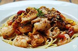 Sweet, tender shrimp and artichoke hearts are sautéed in a special blend of spicy marinara and sweet orange sauce served over linguine pasta