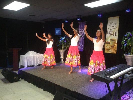 Brethren of Christ.  Hula dancers