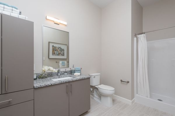 Large bathroom with extra storage space and a walk-in shower