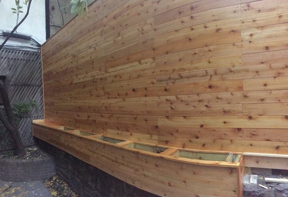 Install the new cedar fence with flower planter boxes.