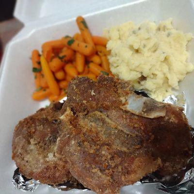 Fried pork chops with glazed carrots and homemade mashed potatoes.