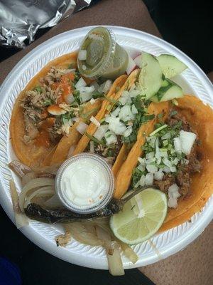 (Left to right) two chicken tacos then al pastor taco with onions and cilantro. It comes with a red salsa (not pictured) and green.