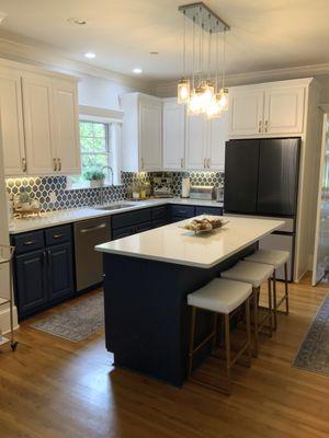 Painted two-toned cabinets, quartz countertops, and mosaic backsplash!