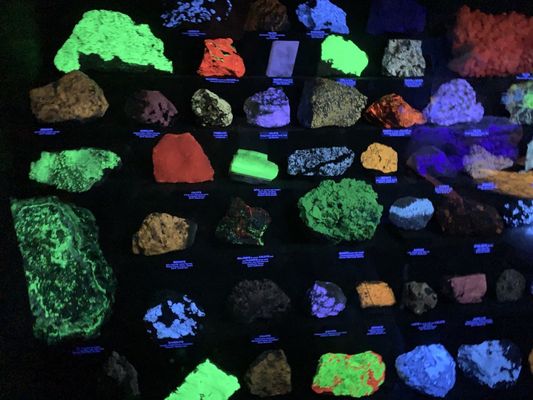 Minerals reflect different colors under fluorescent lights.