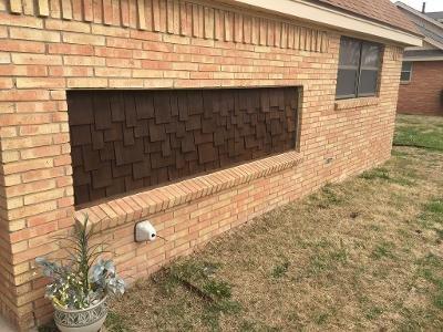 shingles on front house being stained