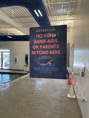 Only swimmers & coaches beyond this door. No gum or bandaids allowed.