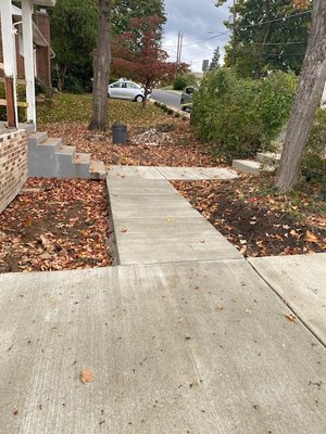 New front walkway connecting the driveway and the city sidewalk to the porch.