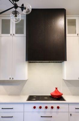 white cabinets with a stained vent hood.