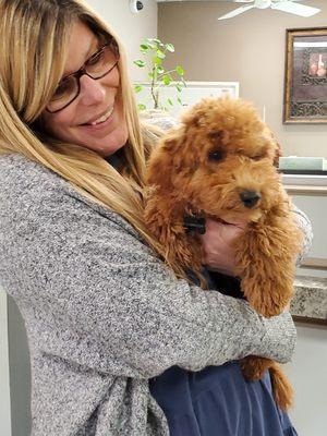 Our Ms. Lori with River one of the many pets that visit us at AFCU.