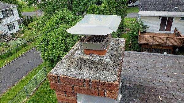 Up on the roof inspecting the chimney.