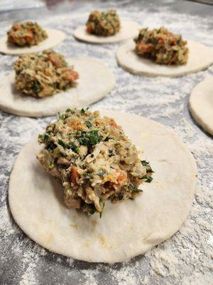 The making of chicken pot pie hand pies.