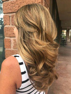 Highlights and lowlights with a bouncy layer blow-dry.