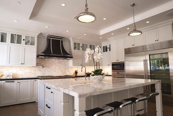 Stone island, kitchen cabinets, countertops, and stone backsplash installed by Kitchen Art in Laguna Hills