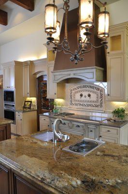 Hidden appliances as well as strategic placement of others makes cooking in the home great family time.