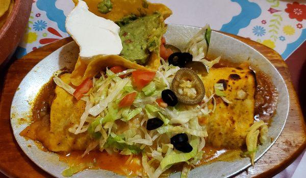 Wet Burrito (beef, pork, refried beans) with red sauce, served with guacamole and sour cream