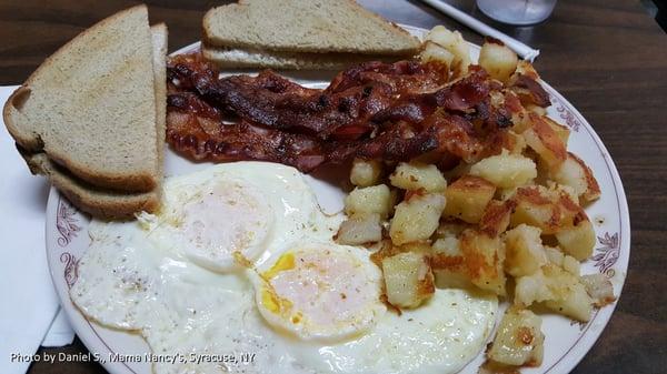 2 eggs, choice of meat, home fries & toast is $6.25 at time of writing for Mama  Nancy's