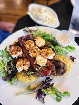 Blackened ribeye topped w/sausage and shrimp over fried green tomatoes.