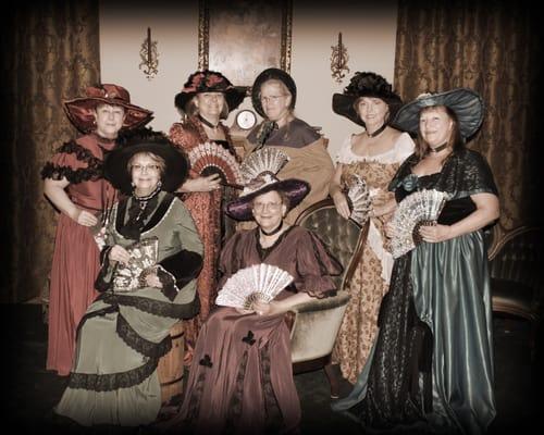 Victorian ladies getting ready for a cup of tea in TNT Old Time Photo in Branson, MO. We love to shoot groups. Come on in!