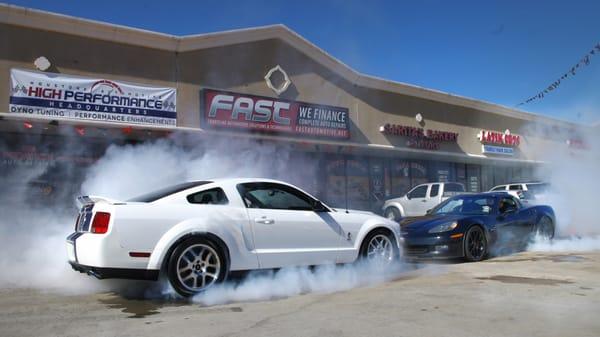 Fast Automotive Cars doing some burnouts in front of our shop.