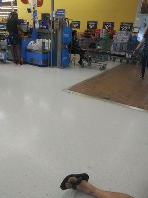 Walmart's employee sitting in a chair a few feet away while I the customer am sitting on the floor