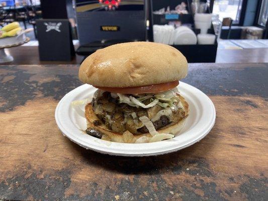 Mushroom, Onion, and Swiss burger with lettuce and tomato.