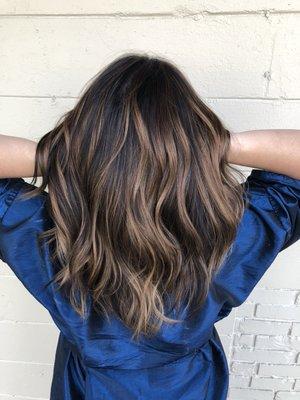 Dimensional Balayage with a deep root melted into pops of the perfect caramel tone!