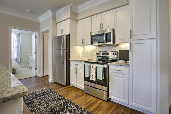 Spacious kitchens with center islands and stainless steel appliances.