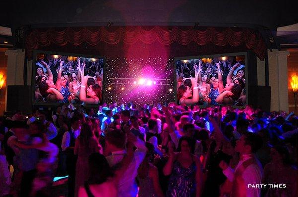 Live video projection on dual screens at prom party.