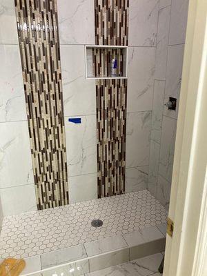 Ceramic wall tile and back splash installed on this stand up shower.